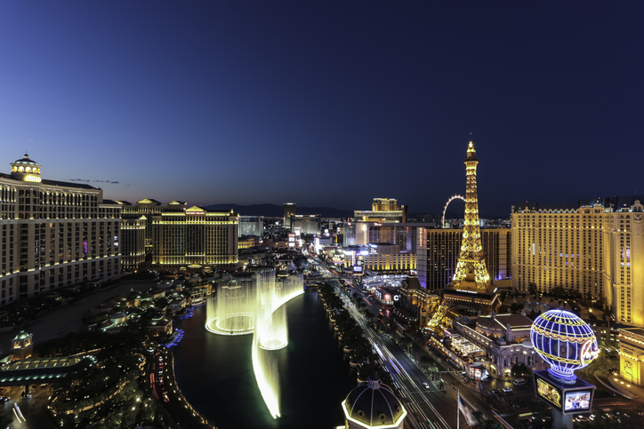 Sunset time high-angle view of the Las Vegas strip featuring the Eiffel tower replica and the fountains of Bellagio as well as the resort hotels Bellagio, Paris-Las Vegas, Ballys and Caesars Palace.